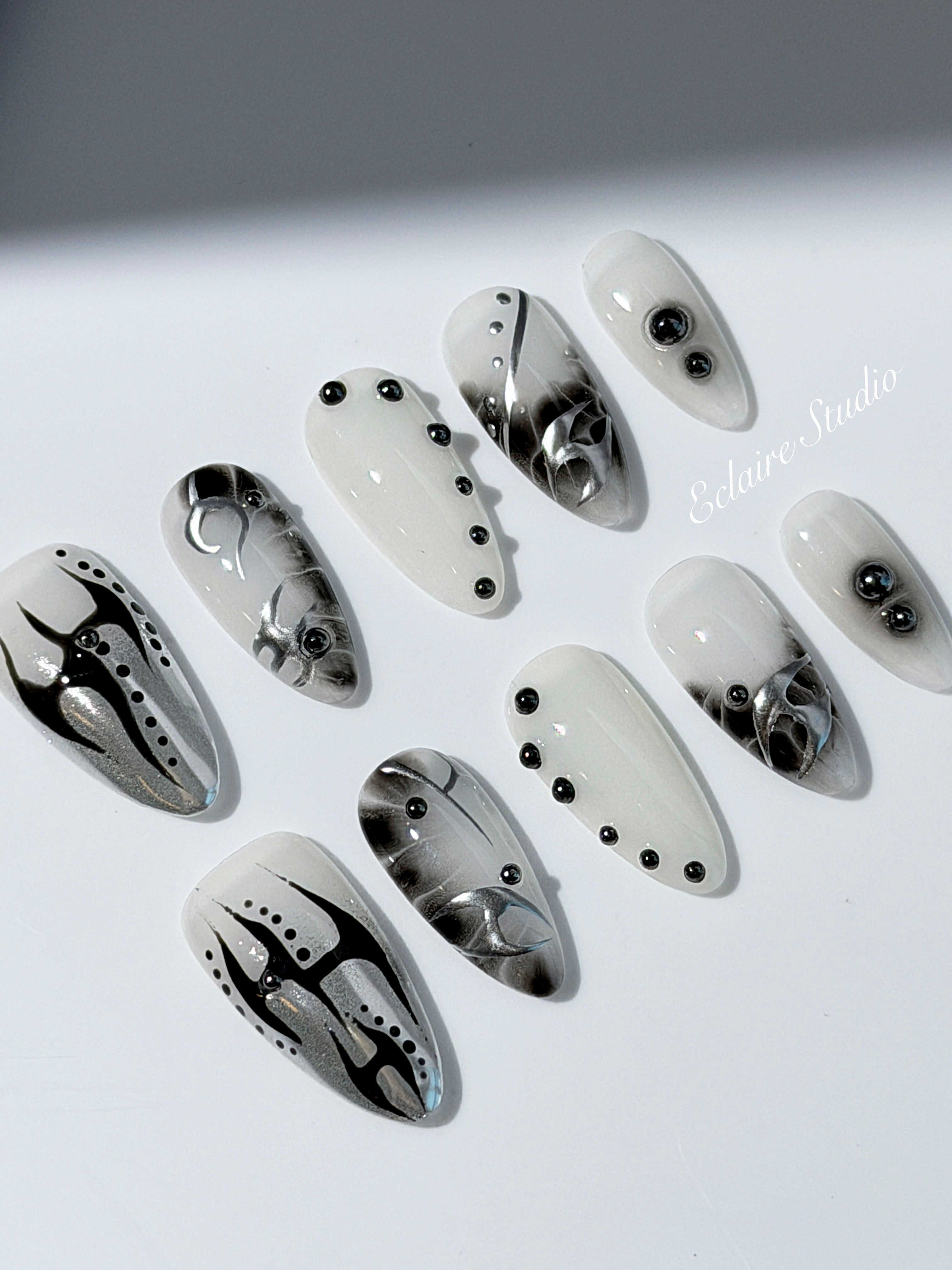 oid Signal press-on nails — a black and grey smoky marble nail design with cyber-inspired line art and glossy onyx studs. Handmade high-fashion nails by Éclaire Nail Studio.”