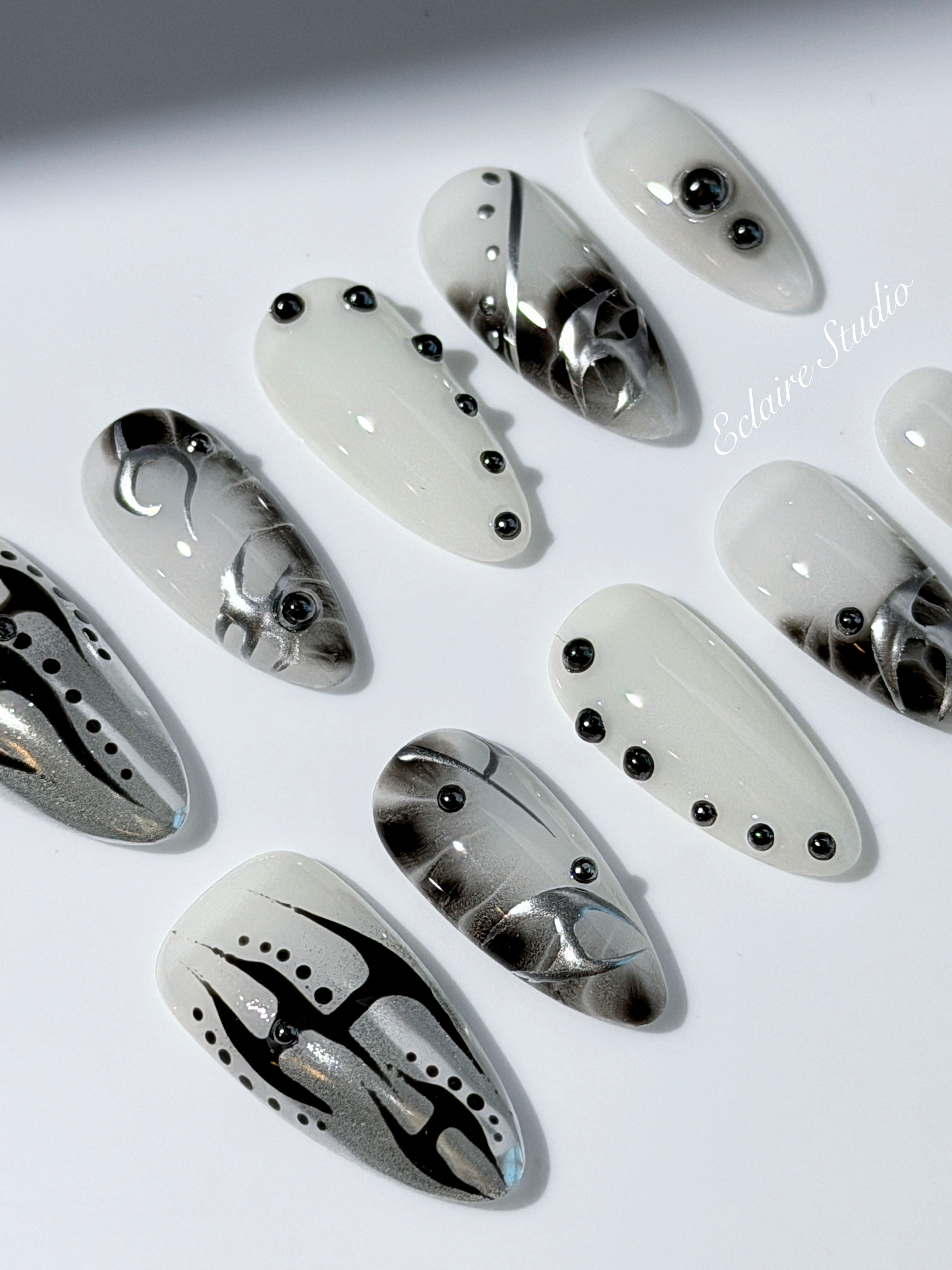 oid Signal press-on nails — a black and grey smoky marble nail design with cyber-inspired line art and glossy onyx studs. Handmade high-fashion nails by Éclaire Nail Studio.”