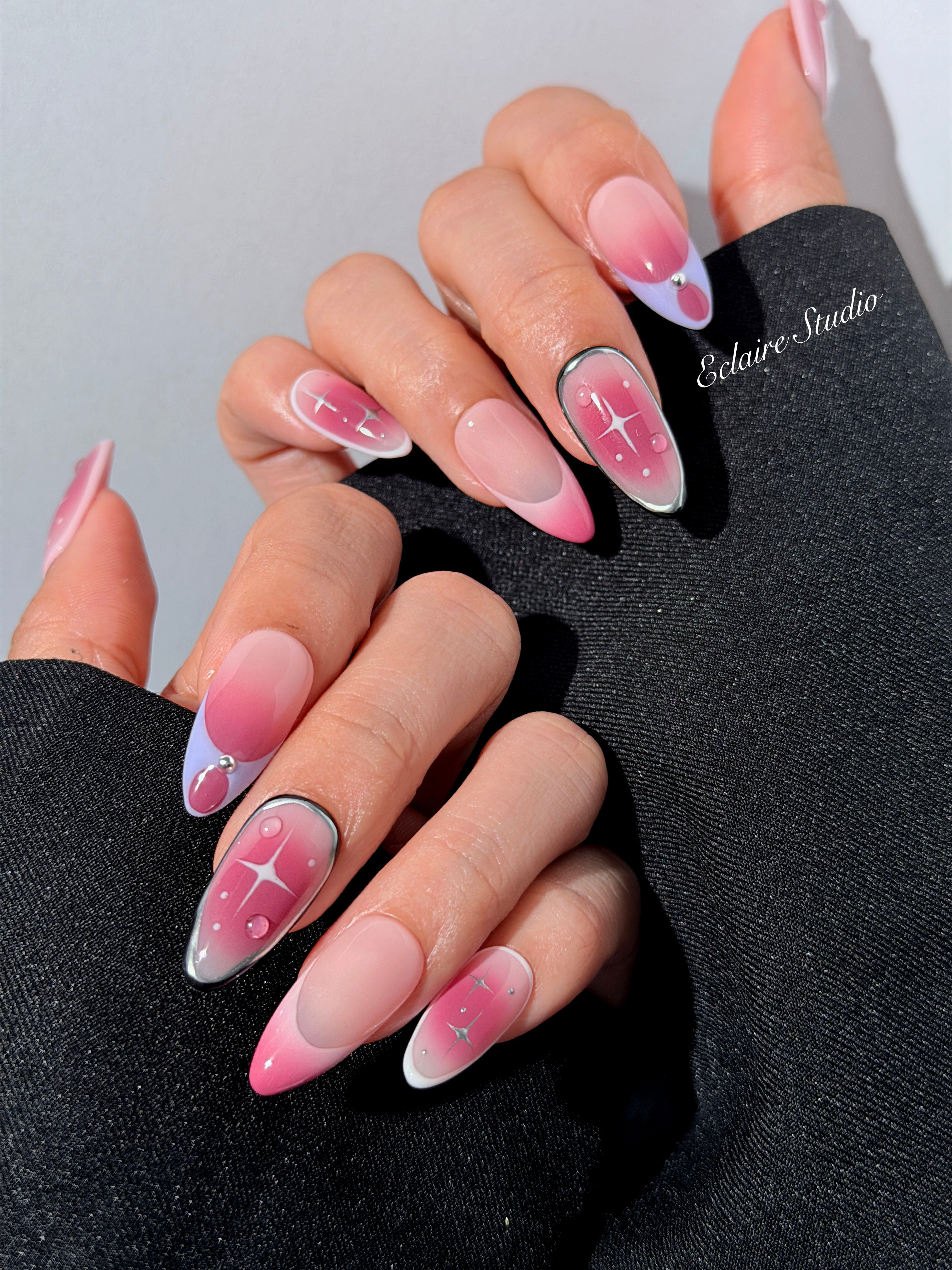 Plum and blush ombré nails with star accents and abstract black outlines — Sugar Plum Fairy–inspired.