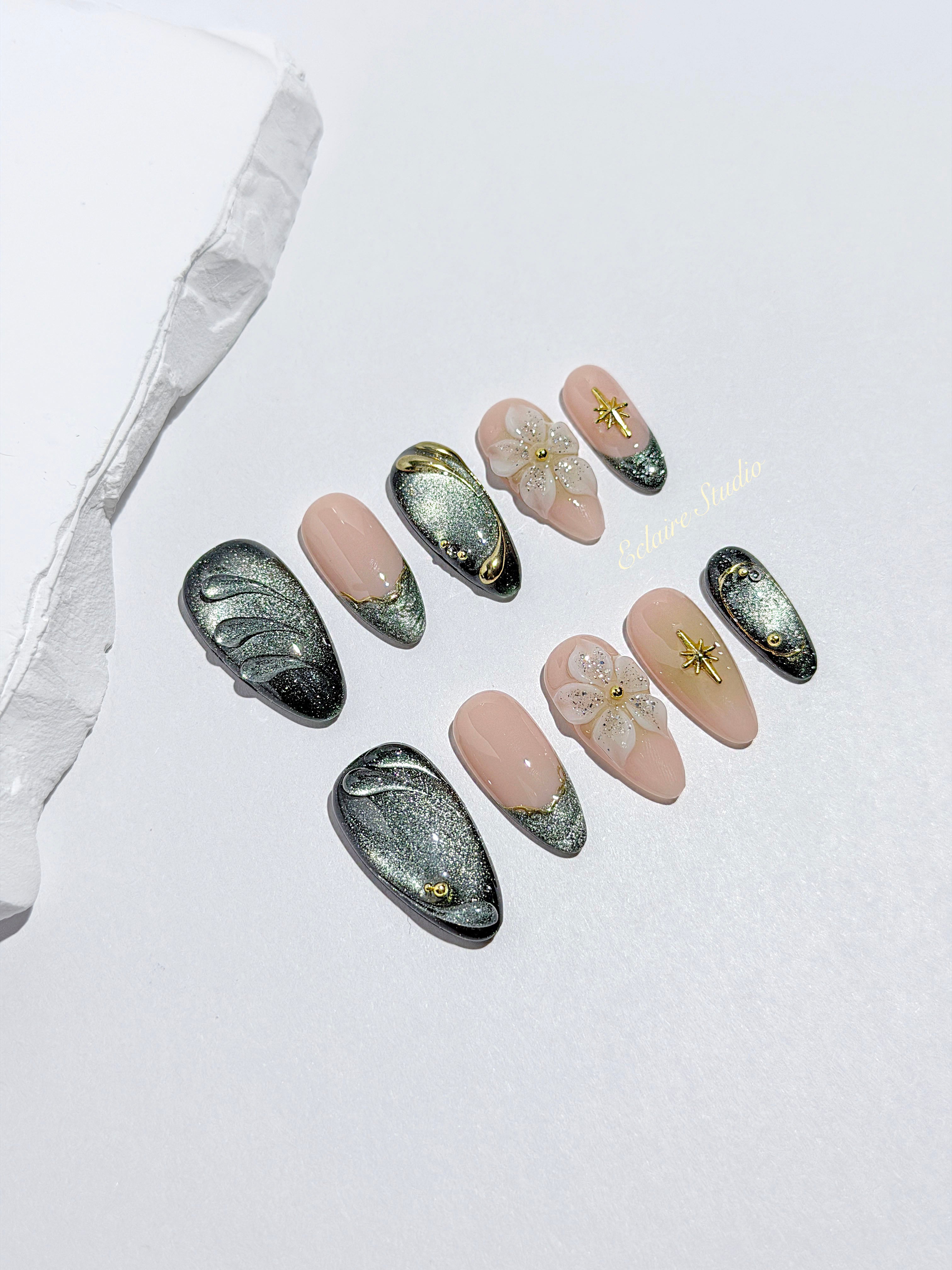 Bali Escape almond press-on nails with emerald cat-eye shimmer, 3D frosted flowers and gold accents – Éclaire Studio