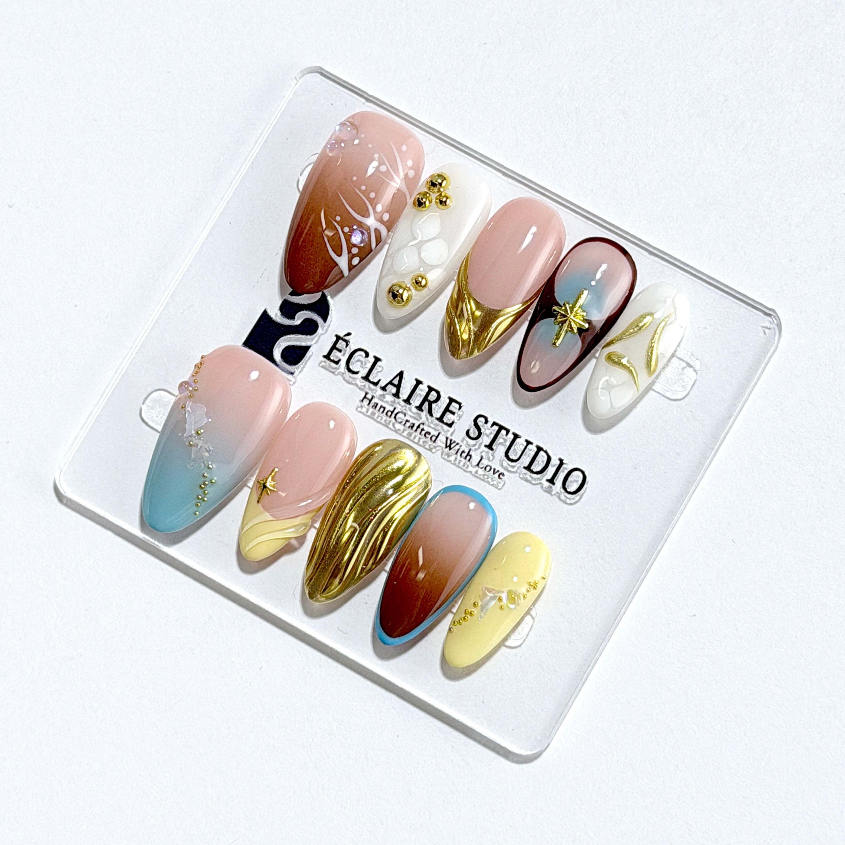 Horizon mixed-tone press-on nails in brown, butter yellow, sky blue and cream with gold chrome wave – Éclaire Studio