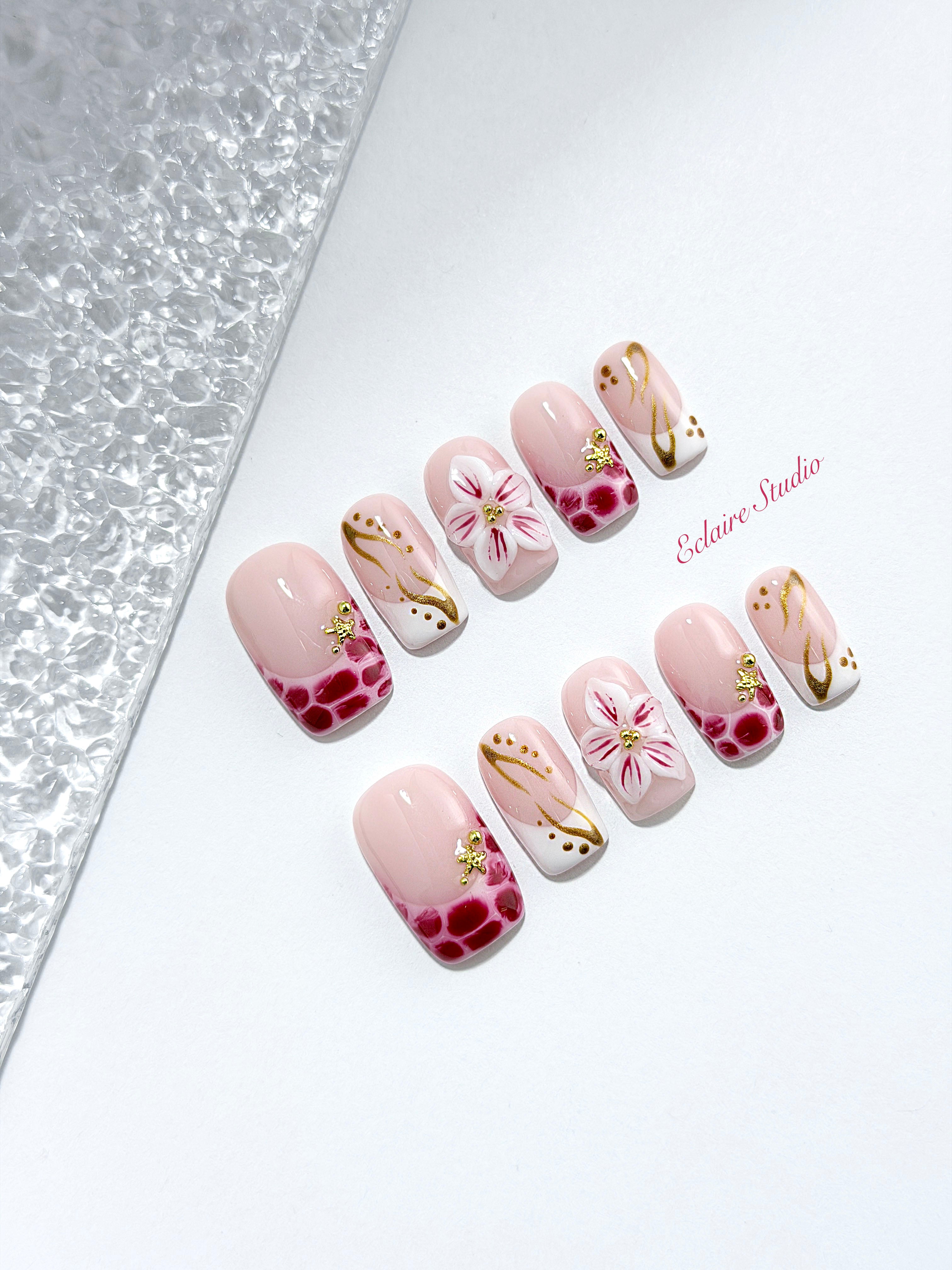 Marbella square press-on nails with wine watercolor French tips, gold swirls, starfish charms and 3D lily – Éclaire Studio