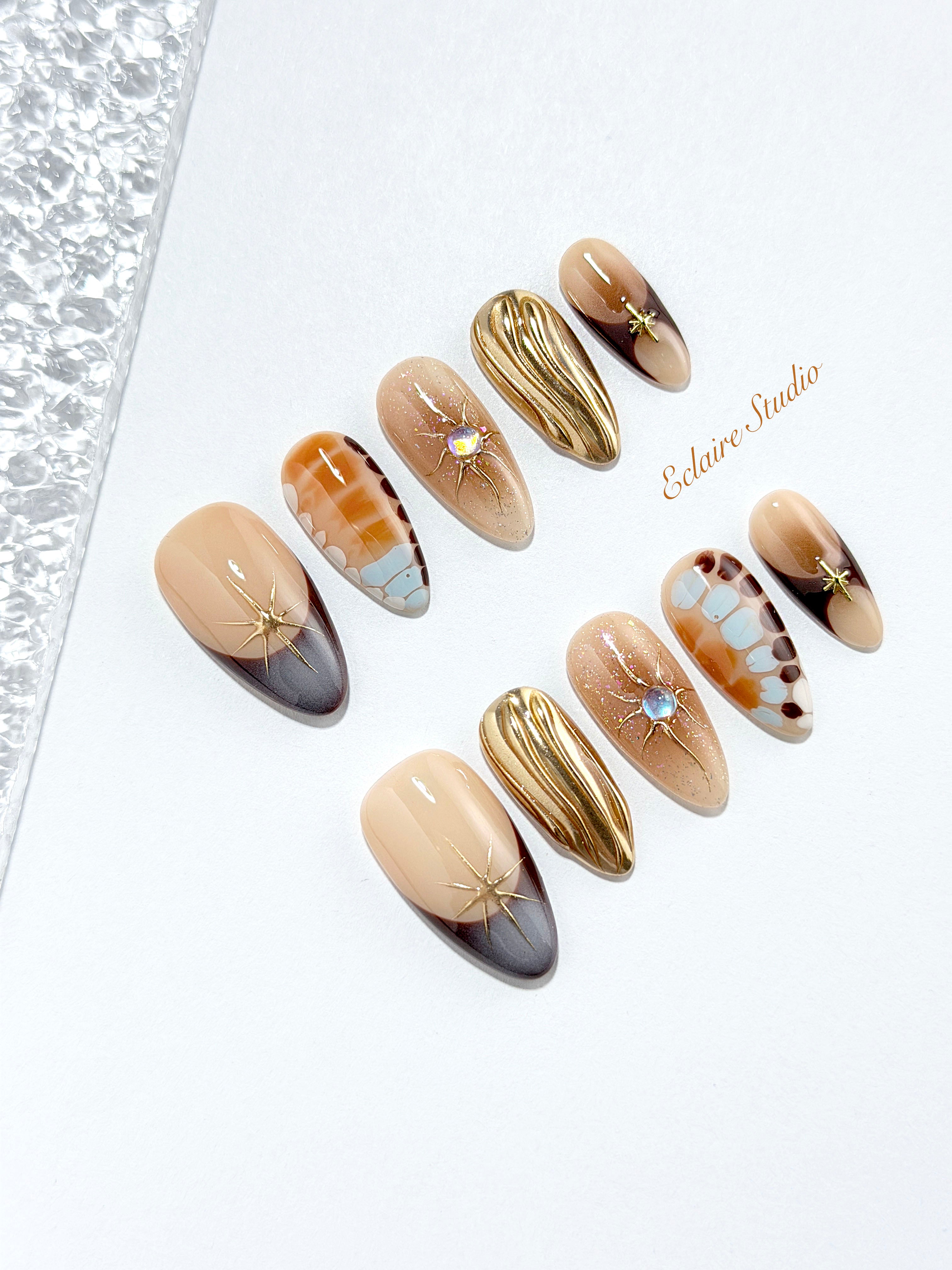 Dune caramel and espresso press-on nails with gold chrome wave, starbursts and opal gem – Éclaire Studio