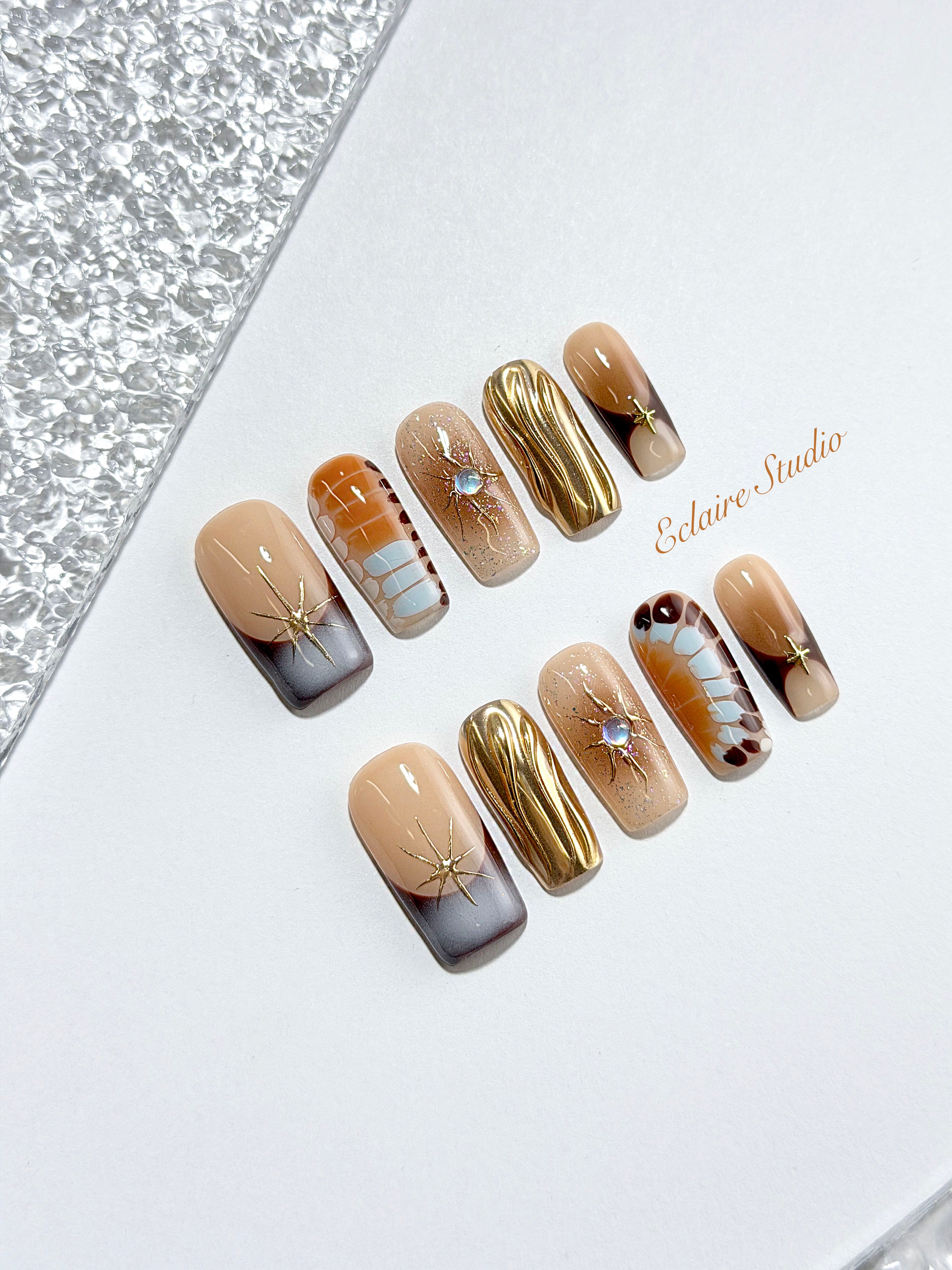 Dune caramel and espresso press-on nails with gold chrome wave, starbursts and opal gem – Éclaire Studio