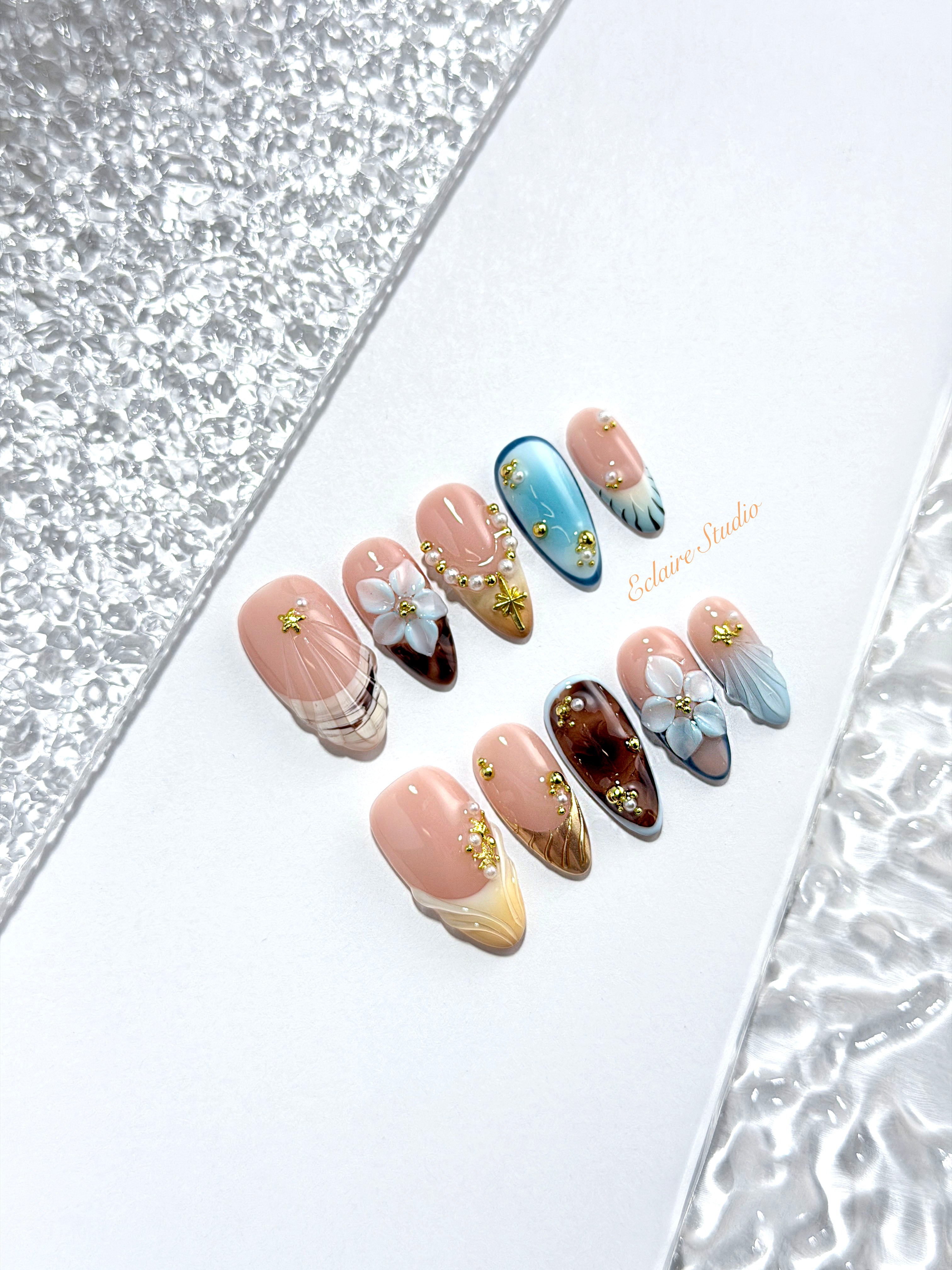 Seabreeze blue-to-amber ombré press-on nails with 3D flowers, pearls and shell French tips – Éclaire Studio