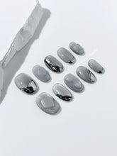 Extra short silver cat-eye press-on nails with chrome ripple accents and 3D heart details, minimalist winter aesthetic.

