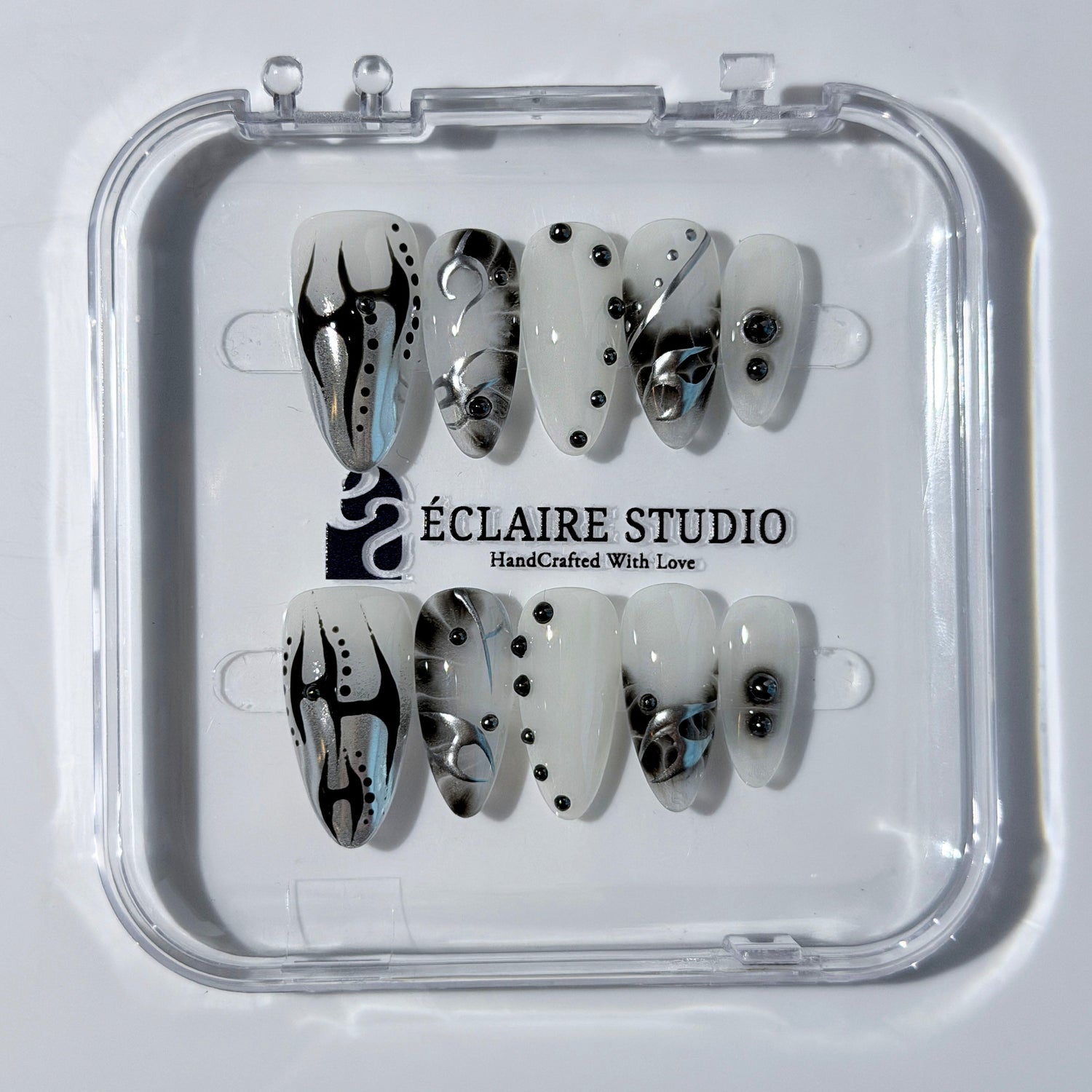 oid Signal press-on nails — a black and grey smoky marble nail design with cyber-inspired line art and glossy onyx studs. Handmade high-fashion nails by Éclaire Nail Studio.