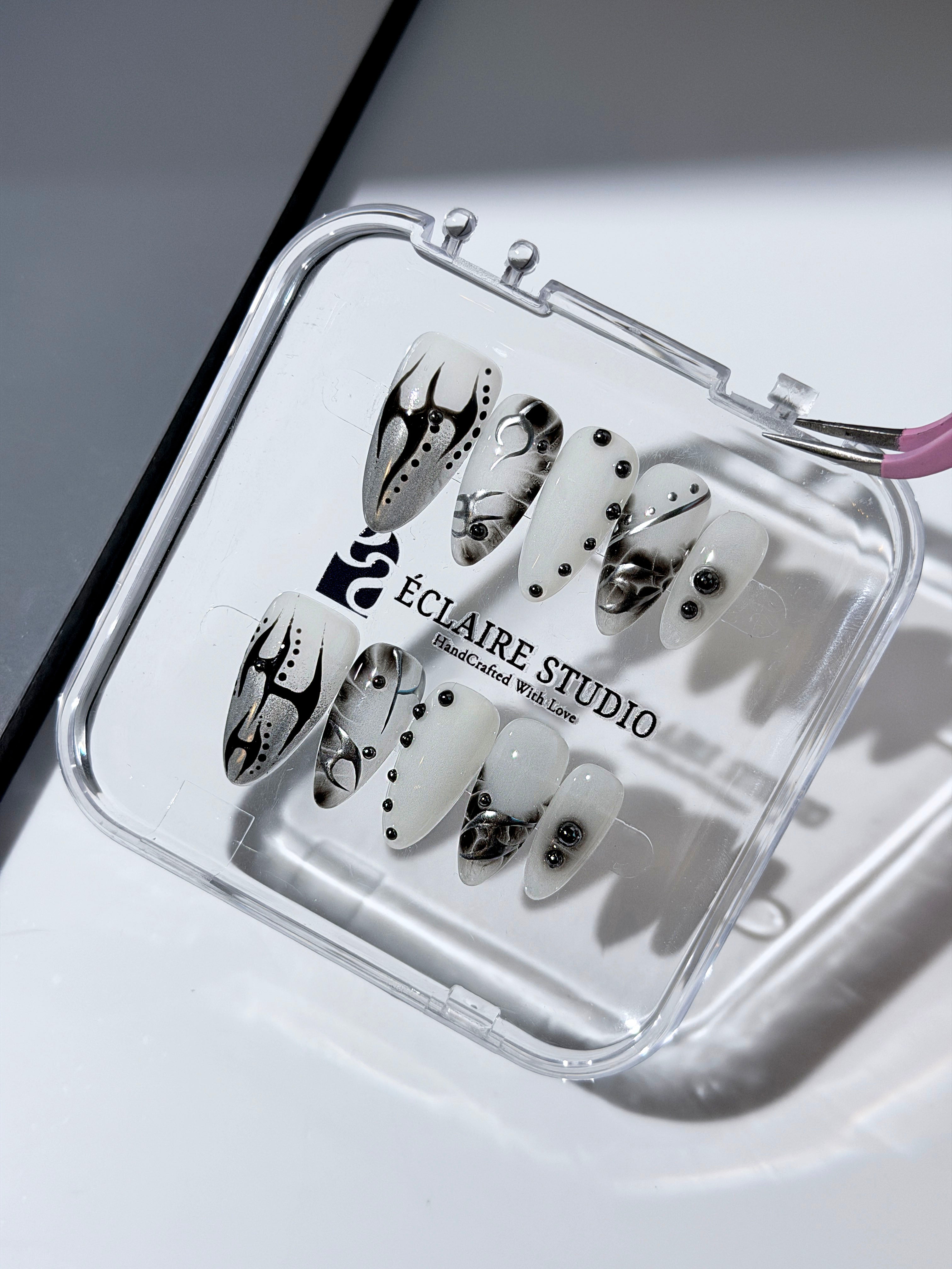 oid Signal press-on nails — a black and grey smoky marble nail design with cyber-inspired line art and glossy onyx studs. Handmade high-fashion nails by Éclaire Nail Studio.