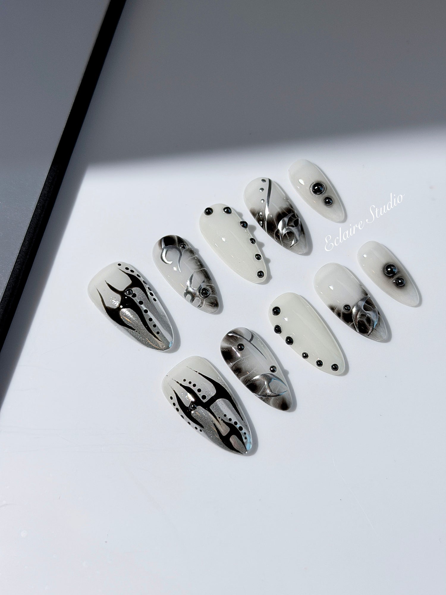 oid Signal press-on nails — a black and grey smoky marble nail design with cyber-inspired line art and glossy onyx studs. Handmade high-fashion nails by Éclaire Nail Studio.”