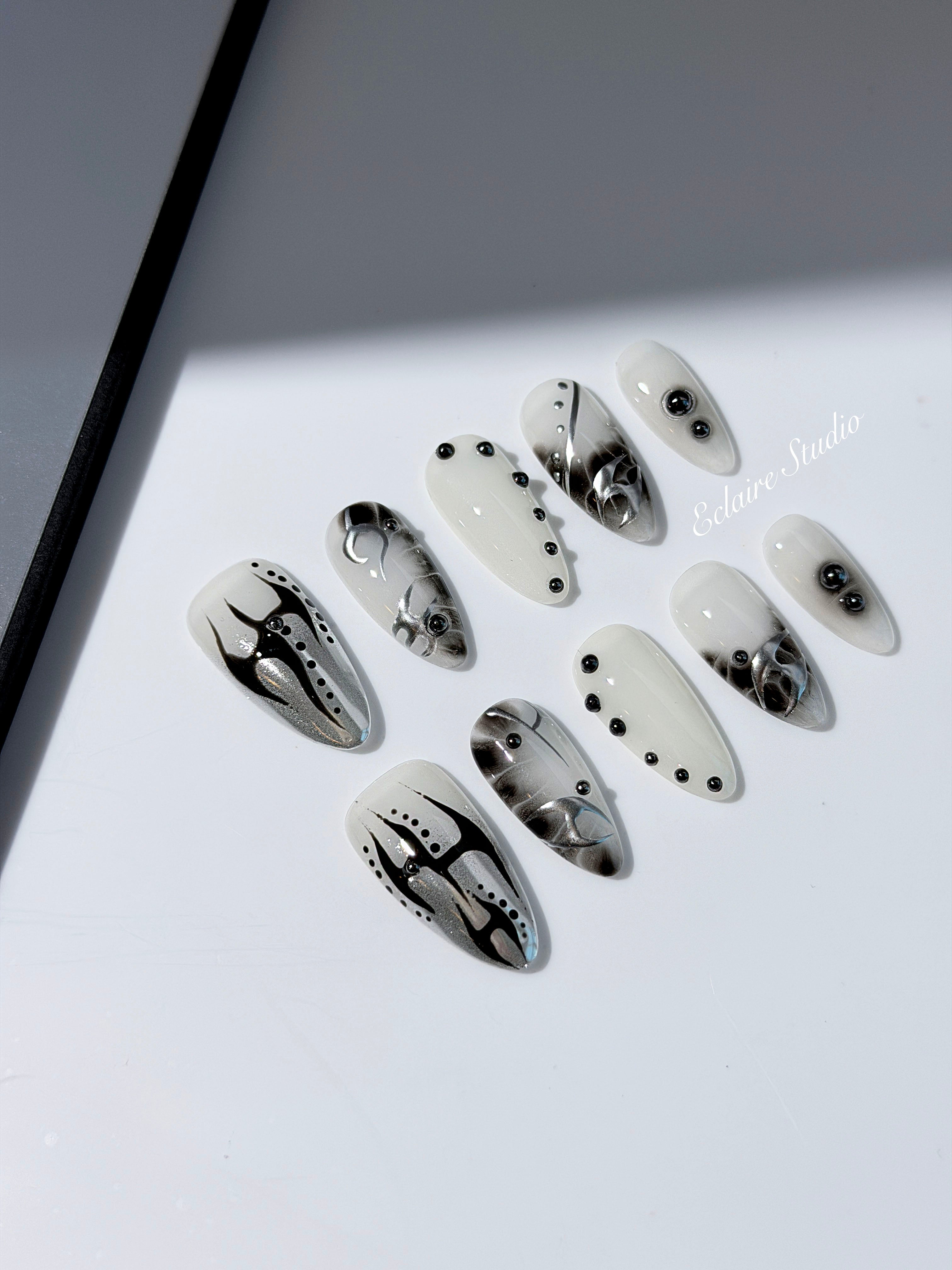 oid Signal press-on nails — a black and grey smoky marble nail design with cyber-inspired line art and glossy onyx studs. Handmade high-fashion nails by Éclaire Nail Studio.”