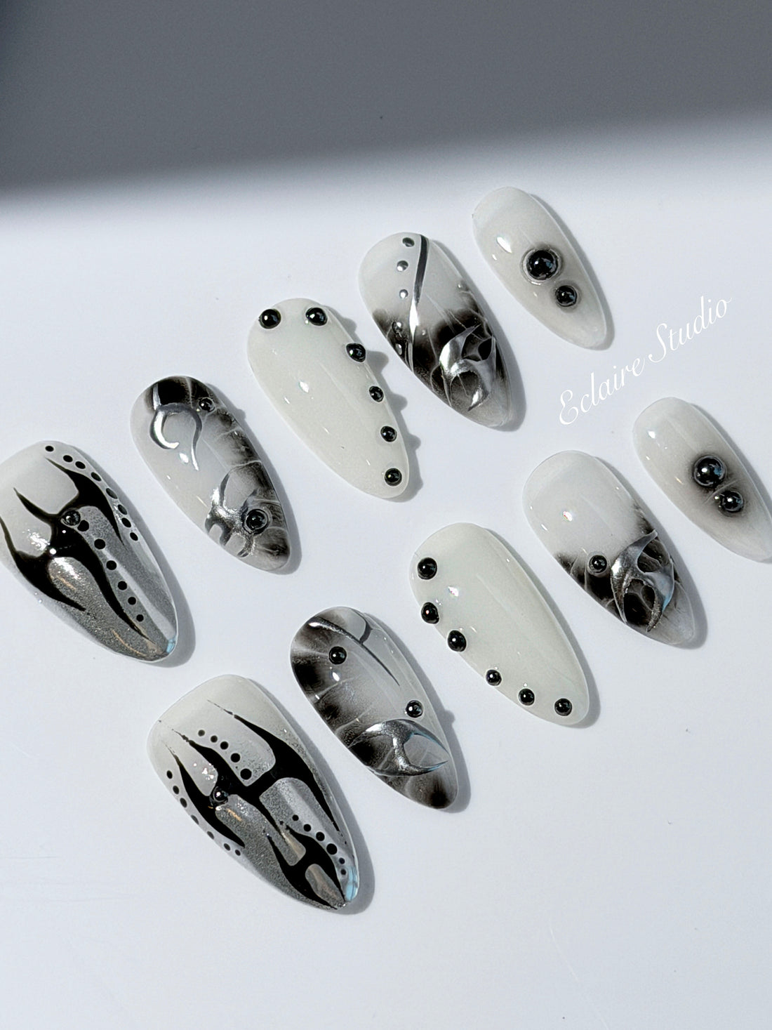 oid Signal press-on nails — a black and grey smoky marble nail design with cyber-inspired line art and glossy onyx studs. Handmade high-fashion nails by Éclaire Nail Studio.”