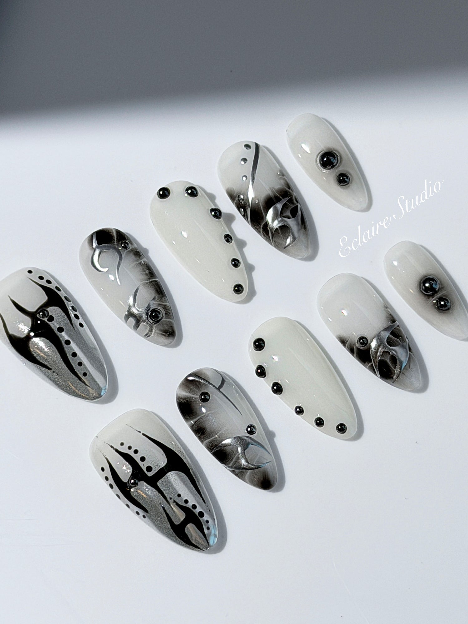oid Signal press-on nails — a black and grey smoky marble nail design with cyber-inspired line art and glossy onyx studs. Handmade high-fashion nails by Éclaire Nail Studio.”