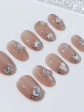 Short milky nude press-on nails with iridescent glitter and 3D crystal droplets, soft winter sugar aesthetic.
