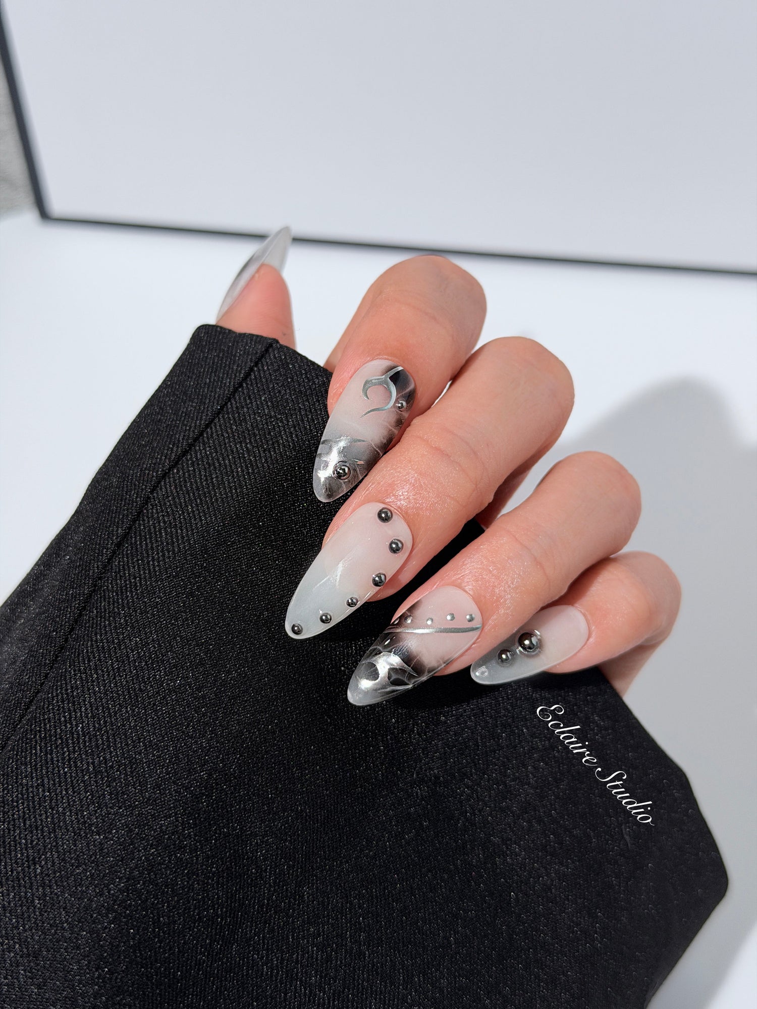 oid Signal press-on nails — a black and grey smoky marble nail design with cyber-inspired line art and glossy onyx studs. Handmade high-fashion nails by Éclaire Nail Studio.”