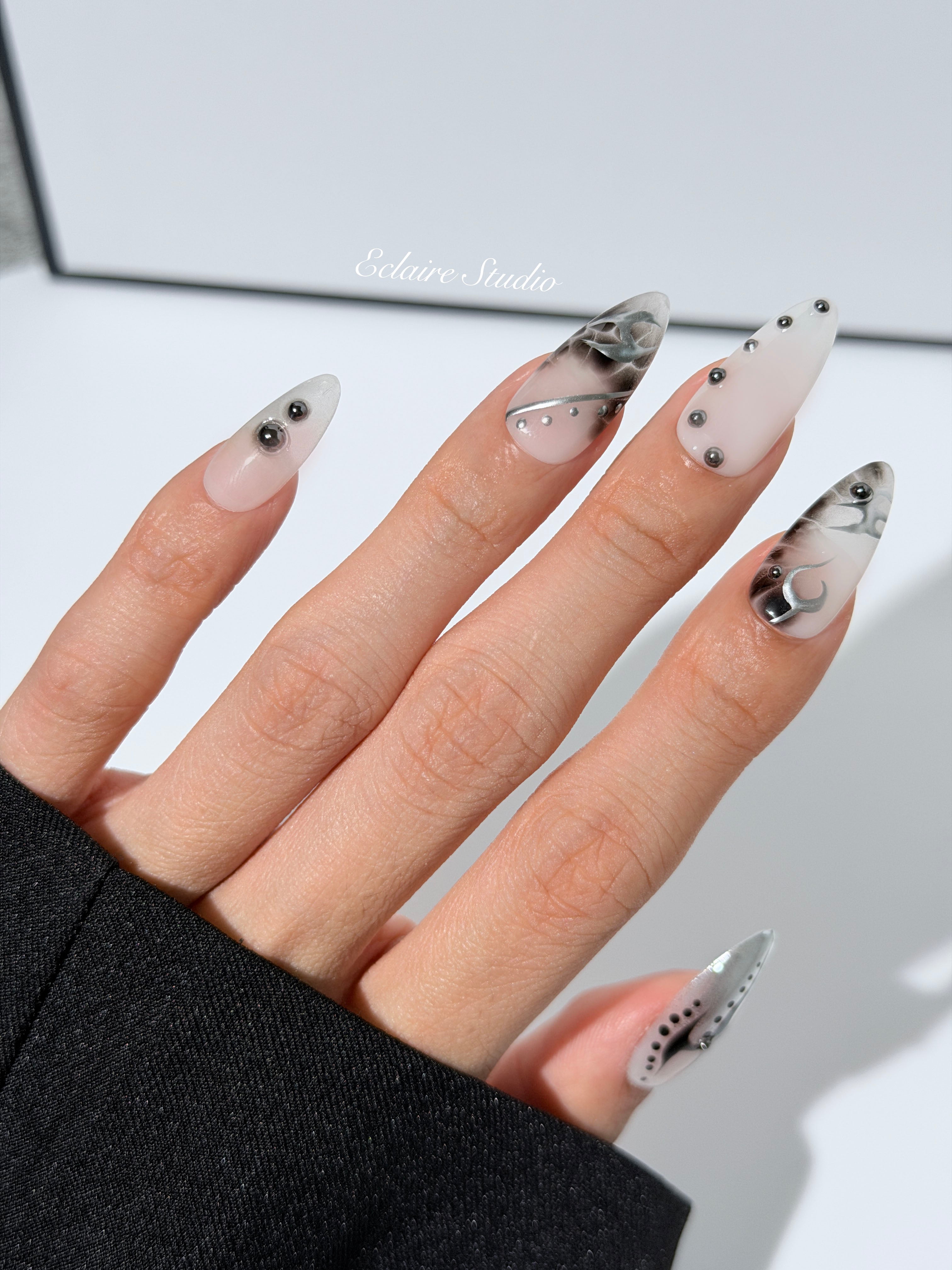 oid Signal press-on nails — a black and grey smoky marble nail design with cyber-inspired line art and glossy onyx studs. Handmade high-fashion nails by Éclaire Nail Studio.”