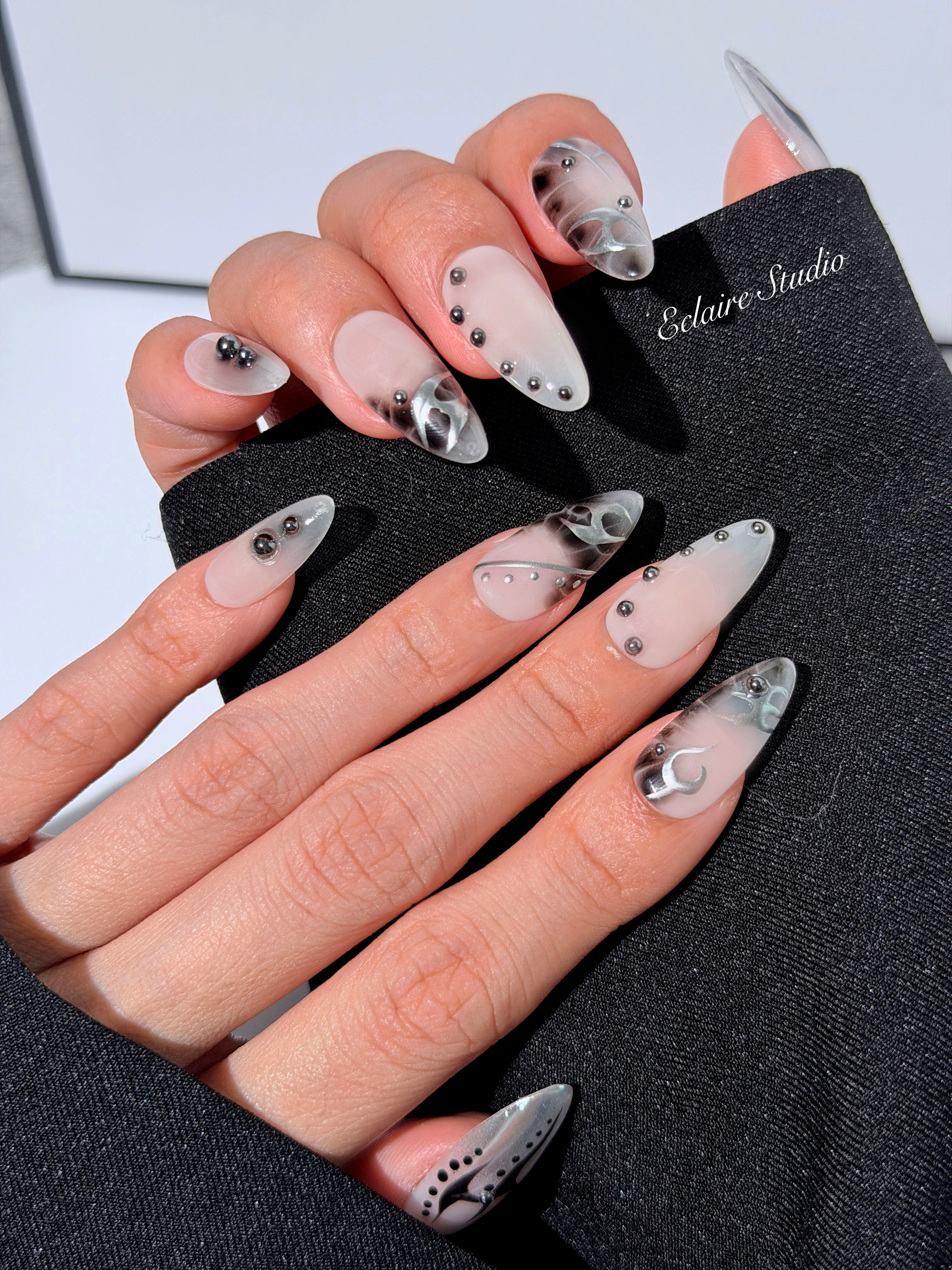 oid Signal press-on nails — a black and grey smoky marble nail design with cyber-inspired line art and glossy onyx studs. Handmade high-fashion nails by Éclaire Nail Studio.”