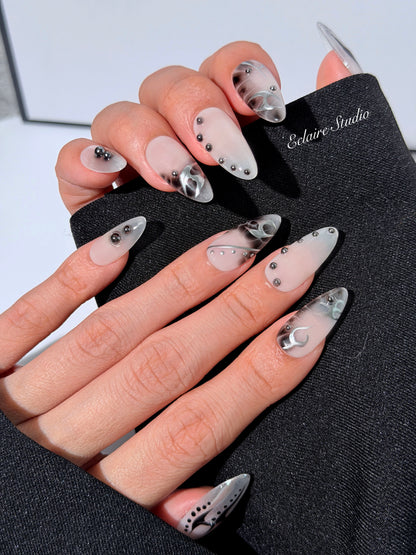 oid Signal press-on nails — a black and grey smoky marble nail design with cyber-inspired line art and glossy onyx studs. Handmade high-fashion nails by Éclaire Nail Studio.”