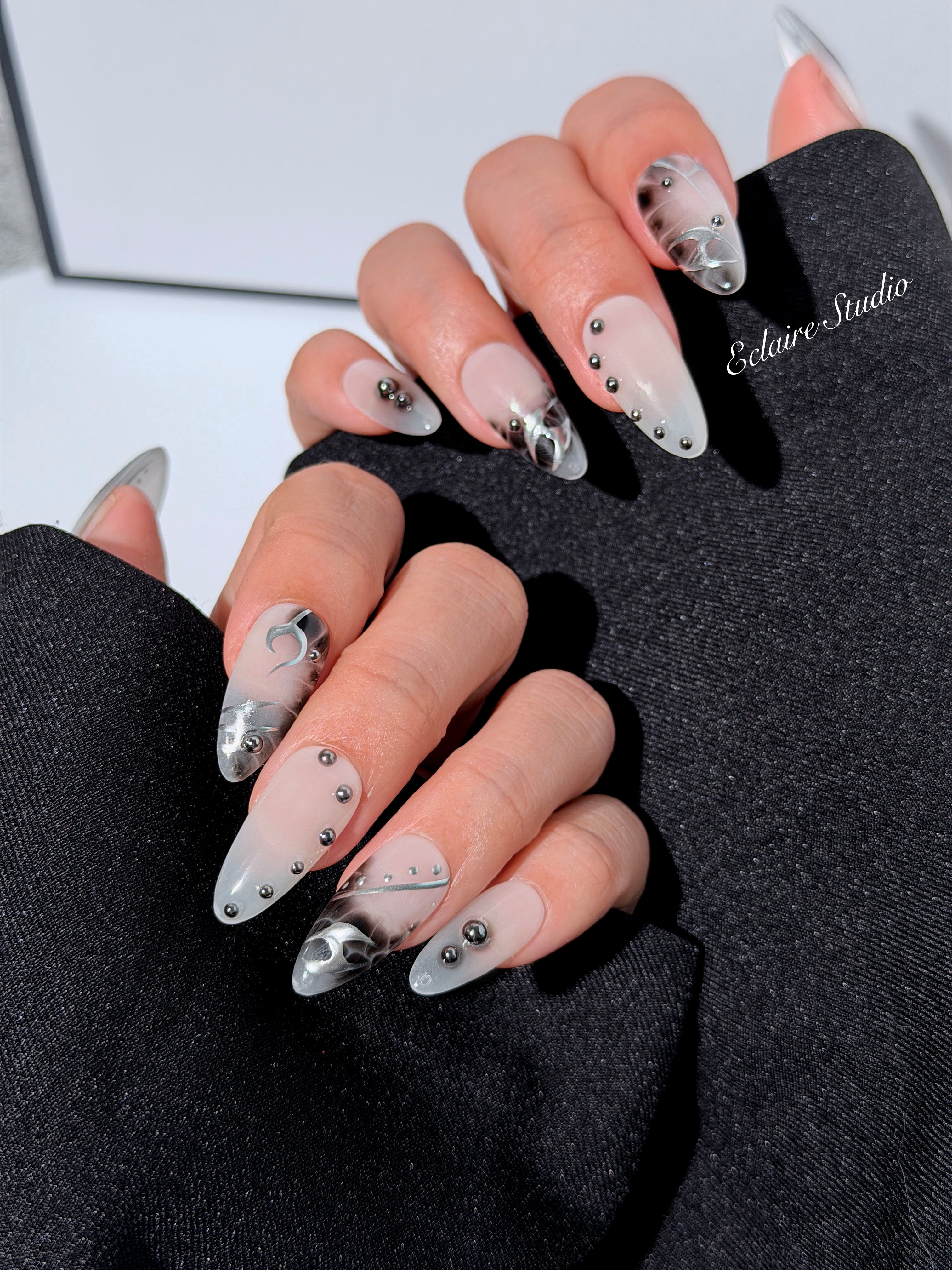 oid Signal press-on nails — a black and grey smoky marble nail design with cyber-inspired line art and glossy onyx studs. Handmade high-fashion nails by Éclaire Nail Studio.”