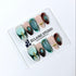 Jasmine’s Secret almond press-on nails with teal and blush bases, tortoiseshell French tips, turquoise-toned oval jewels, gold frames, and gold beads.