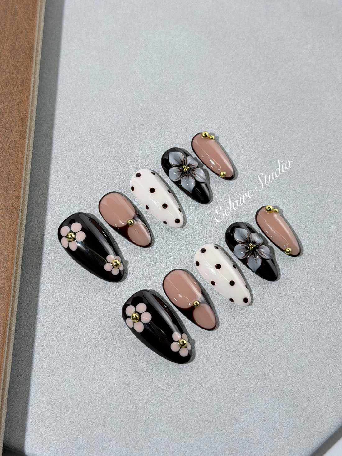 Cocoa Cameo almond press-on nails with espresso and blush bases, polka dots, sculpted flowers and gold beads – Éclaire Studio