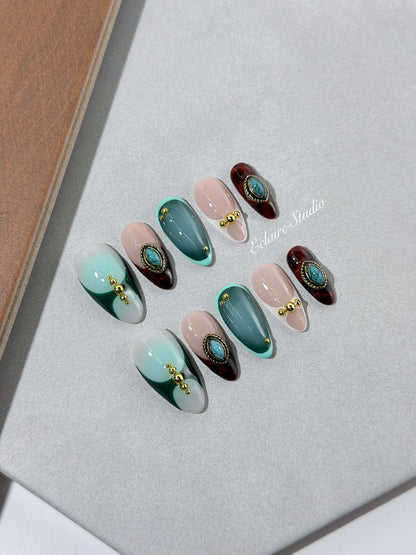 Jasmine’s Secret almond press-on nails with teal and blush bases, tortoiseshell French tips and turquoise jewels – Éclaire Studio