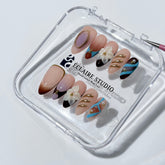 Warm gradient nails with gold trim, 3D white flowers, and blue accents inspired by the Nutcracker character