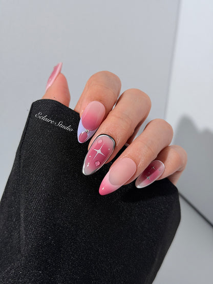 Plum and blush ombré nails with star accents and abstract black outlines — Sugar Plum Fairy–inspired.