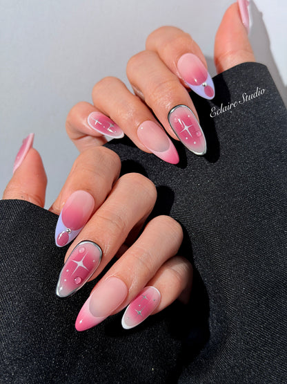 Plum and blush ombré nails with star accents and abstract black outlines — Sugar Plum Fairy–inspired.