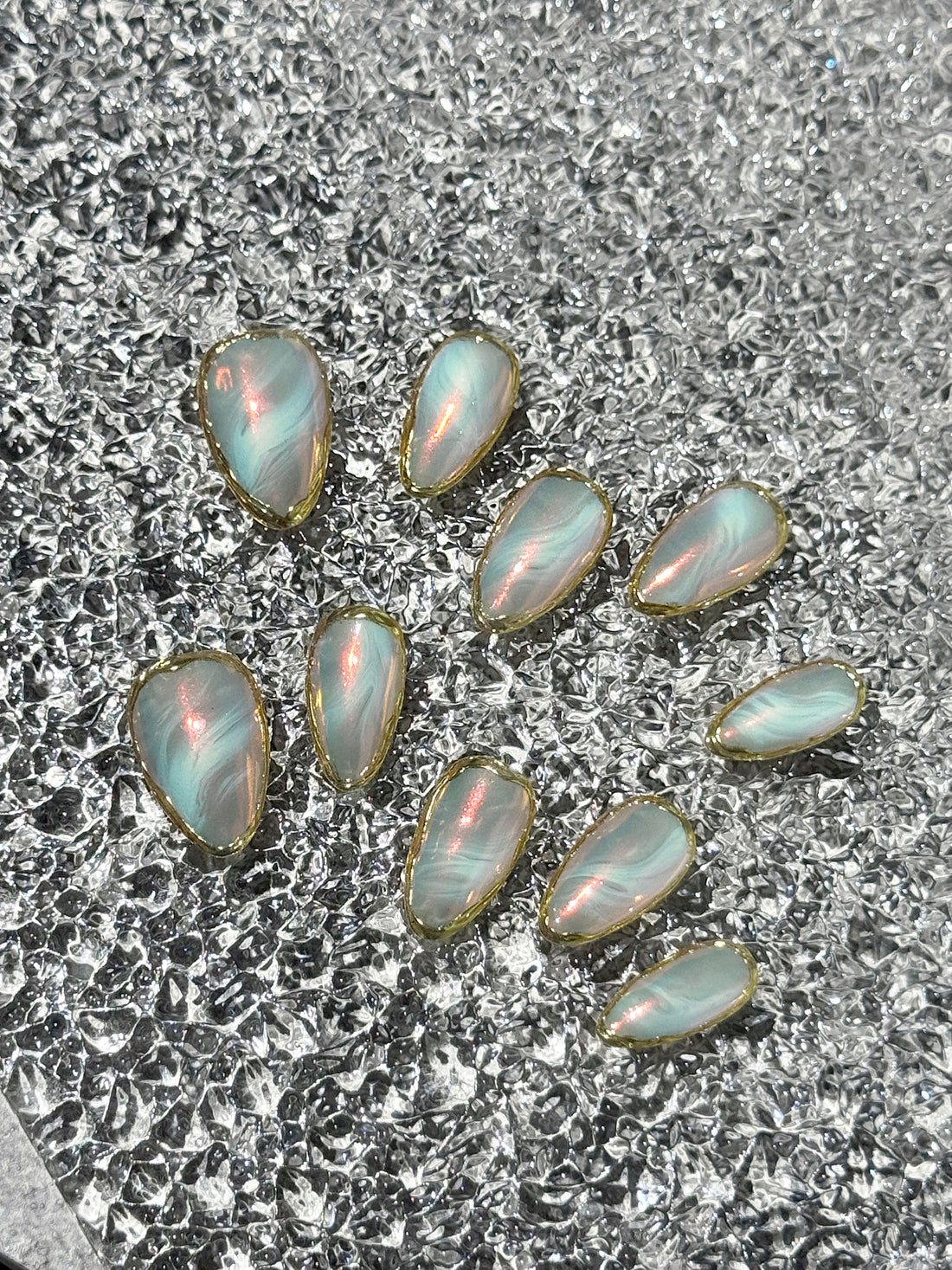 Opal stones on a textured gray surface