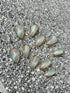 Opal stones on a textured gray surface