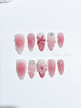Luxury press-on nails featuring a soft blush pink ombre base with white French tips, a translucent 3D jellyfish, a sculpted pink starfish, and a clear 3D glass flower with a pearl center.