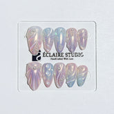 Handcrafted luxury press-on nails in a medium almond shape featuring an iridescent multi-toned glazed finish with 3D sculpted shell ridges and delicate mini pearls.