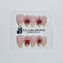 Luxury short almond press-on nails featuring sheer pink bases with vintage cream French tips, burgundy polka dots, and hand-sculpted 3D burgundy flowers with gold bead centers.