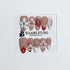 Rouge press-on nails with red linework and 3D white florals on a nude base – Éclaire Studio