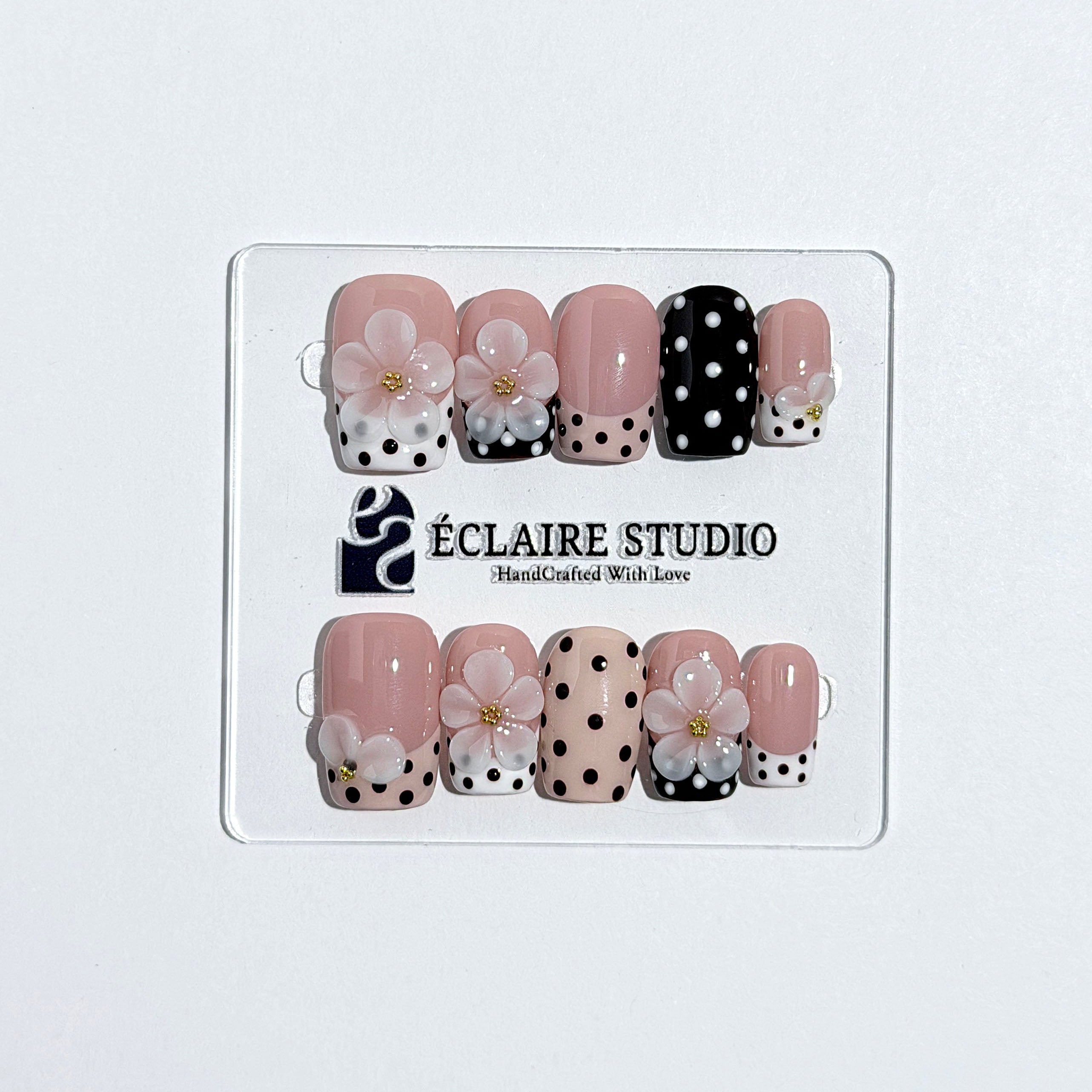 Eclaire Nail Studio 3D Floral Polka dot pink base with alternating black and white polka dot French tips, and hand-sculpted 3D frosted white flowers with gold bead centers, Medium Square