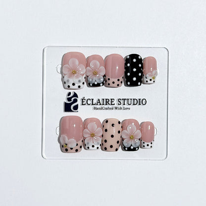 Eclaire Nail Studio 3D Floral Polka dot pink base with alternating black and white polka dot French tips, and hand-sculpted 3D frosted white flowers with gold bead centers, Medium Square
