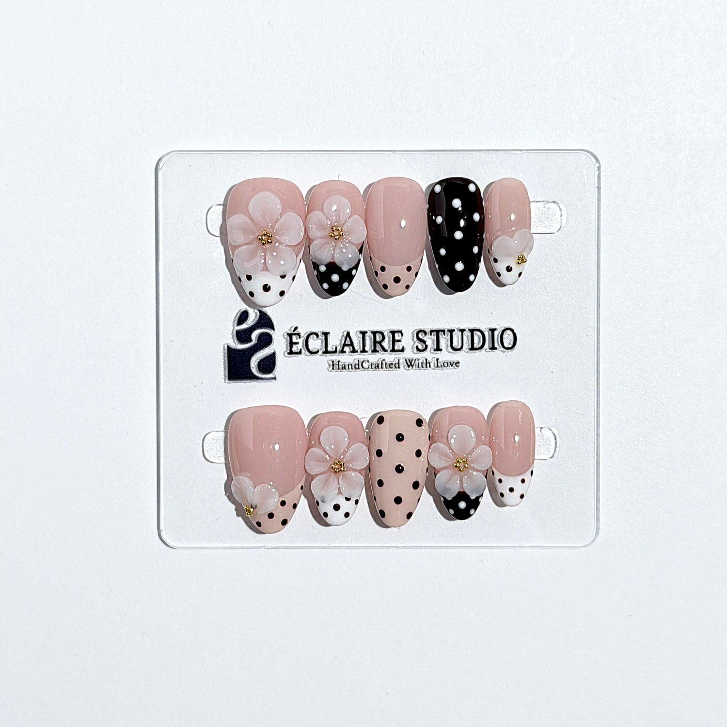 Eclaire Nail Studio 3D Floral Polka dot pink base with alternating black and white polka dot French tips, and hand-sculpted 3D frosted white flowers with gold bead centers, Short Almond