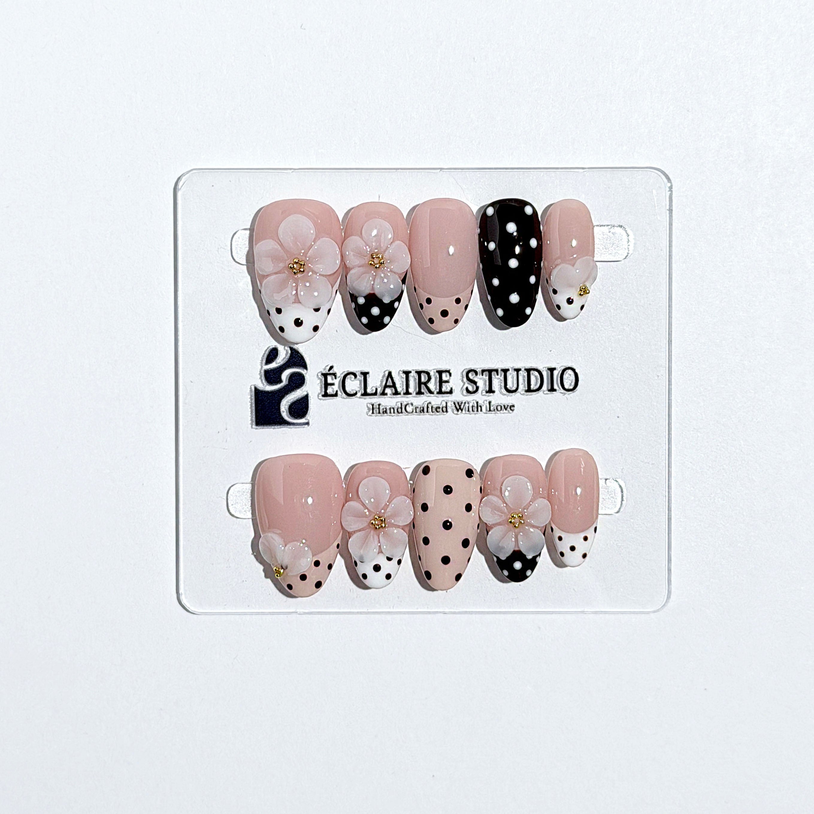 Eclaire Nail Studio 3D Floral Polka dot pink base with alternating black and white polka dot French tips, and hand-sculpted 3D frosted white flowers with gold bead centers, Short Almond