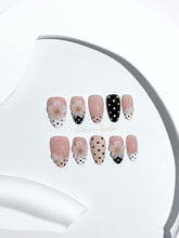 Eclaire Nail Studio 3D Floral Polka dot pink base with alternating black and white polka dot French tips, and hand-sculpted 3D frosted white flowers with gold bead centers, Short Almond