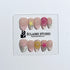 Eclaire Studio 3D Summer short almond press-on nails with sheer nude bases, sparkling silver cat-eye magnetic French tips, hand-painted colorful starfish, and pink 3D sculpted seashells.