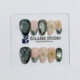Bali Escape almond press-on nails with emerald cat-eye shimmer, 3D frosted flowers and gold accents – Éclaire Studio