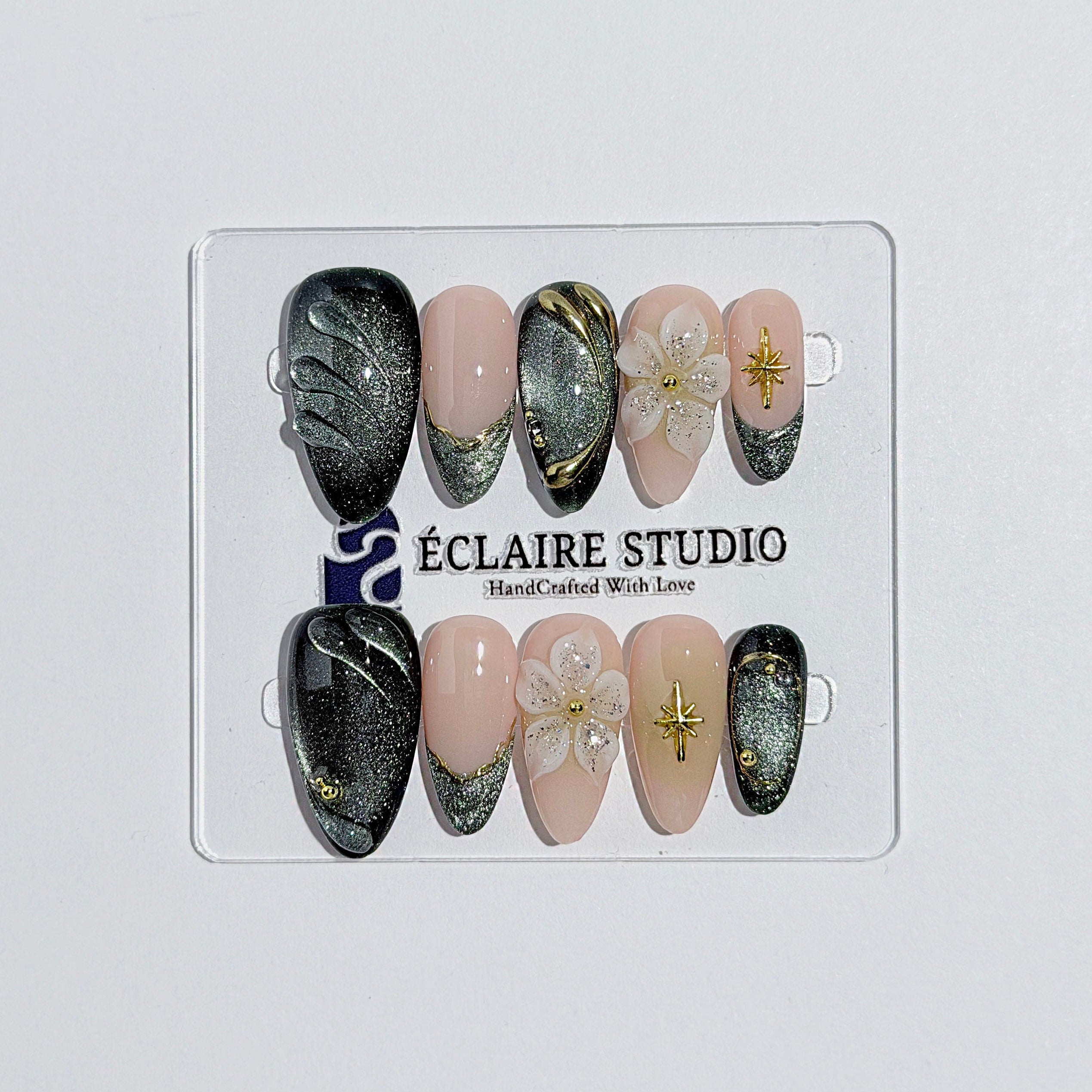Bali Escape almond press-on nails with emerald cat-eye shimmer, 3D frosted flowers and gold accents – Éclaire Studio