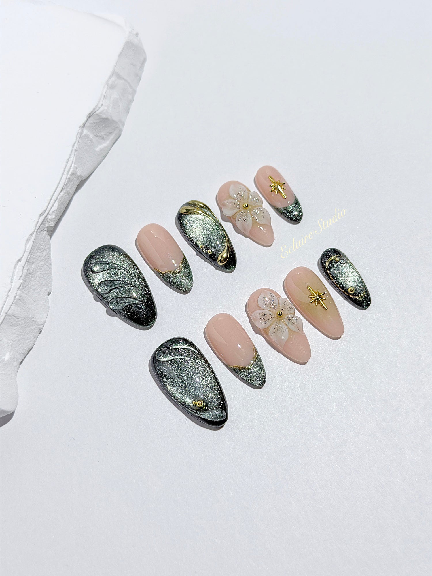 Bali Escape almond press-on nails with emerald cat-eye shimmer, 3D frosted flowers and gold accents – Éclaire Studio