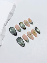 Bali Escape almond press-on nails with emerald cat-eye shimmer, 3D frosted flowers and gold accents – Éclaire Studio