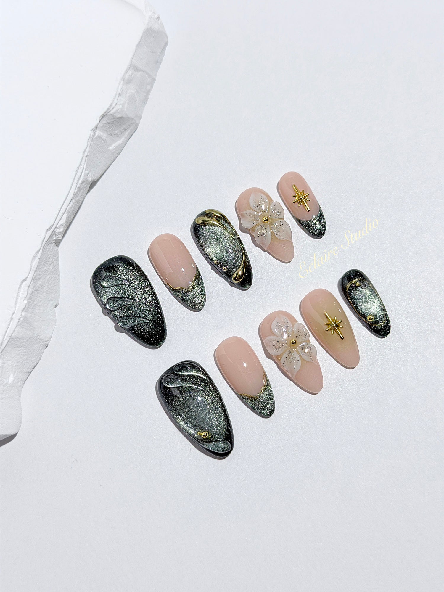 Bali Escape almond press-on nails with emerald cat-eye shimmer, 3D frosted flowers and gold accents – Éclaire Studio