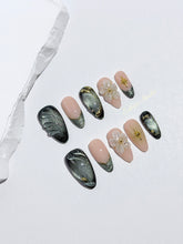 Bali Escape almond press-on nails with emerald cat-eye shimmer, 3D frosted flowers and gold accents – Éclaire Studio