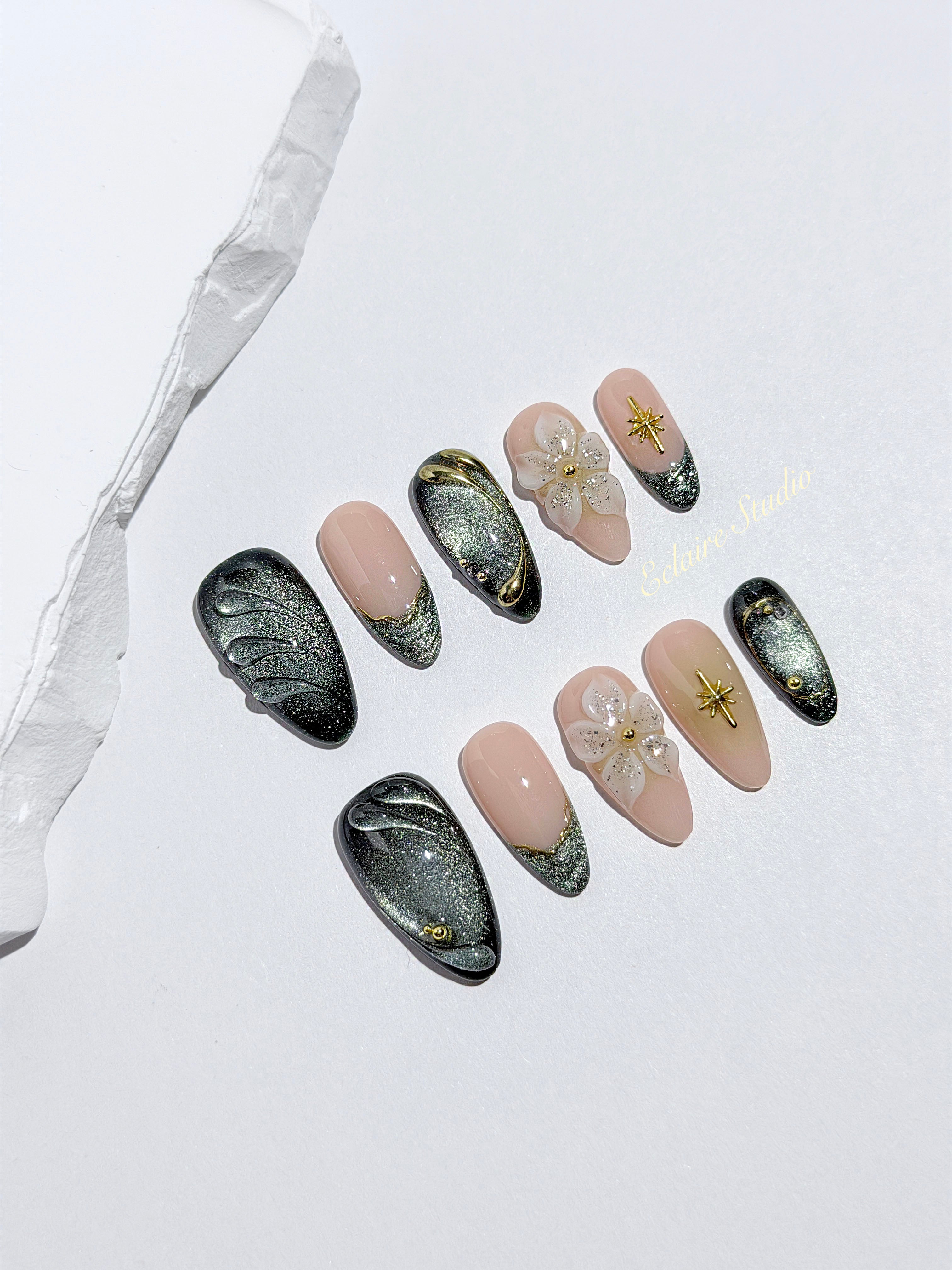 Bali Escape almond press-on nails with emerald cat-eye shimmer, 3D frosted flowers and gold accents – Éclaire Studio