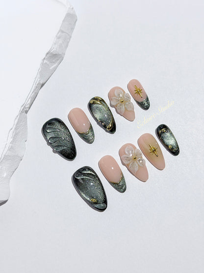Bali Escape almond press-on nails with emerald cat-eye shimmer, 3D frosted flowers and gold accents – Éclaire Studio
