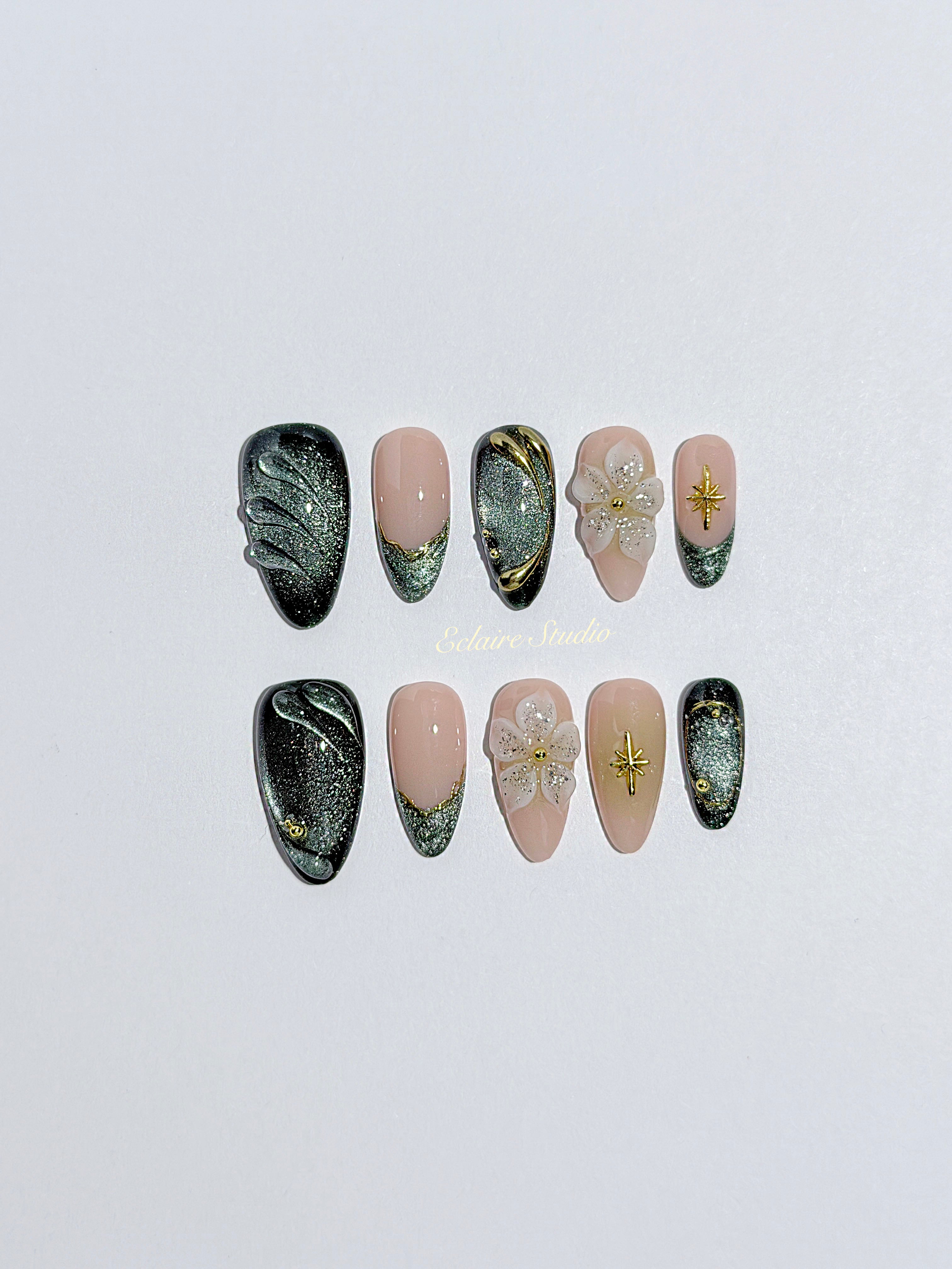 Bali Escape almond press-on nails with emerald cat-eye shimmer, 3D frosted flowers and gold accents – Éclaire Studio