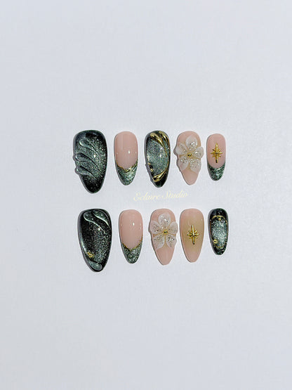 Bali Escape almond press-on nails with emerald cat-eye shimmer, 3D frosted flowers and gold accents – Éclaire Studio